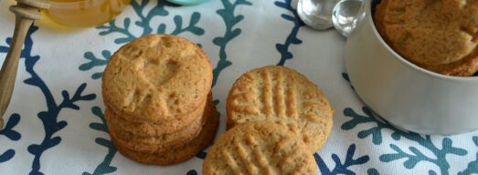 Biscotti su tovaglietta con vasetto di miele e latte