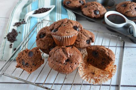 Gratella su tavola bianca con muffin e decorazione di cioccolato e amarene